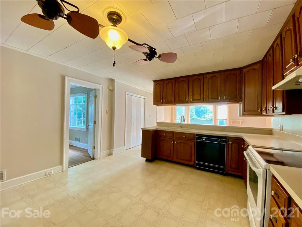 8930 Cool Springs Road Woodleaf, NC 27054 - Photo 22 of 42 a kitchen with stainless steel appliances granite countertop a refrigerator a sink dishwasher a stove a dining table and chairs with wooden floor