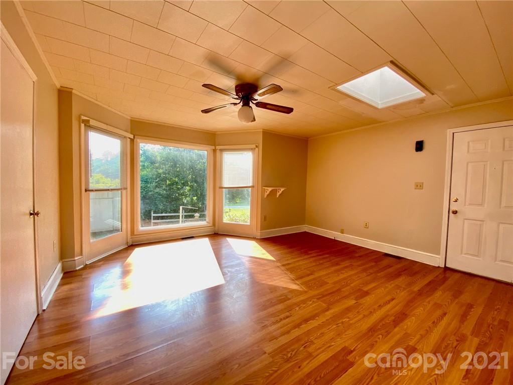 8930 Cool Springs Road Woodleaf, NC 27054 - Photo 25 of 42 a view of an empty room with wooden floor and a window