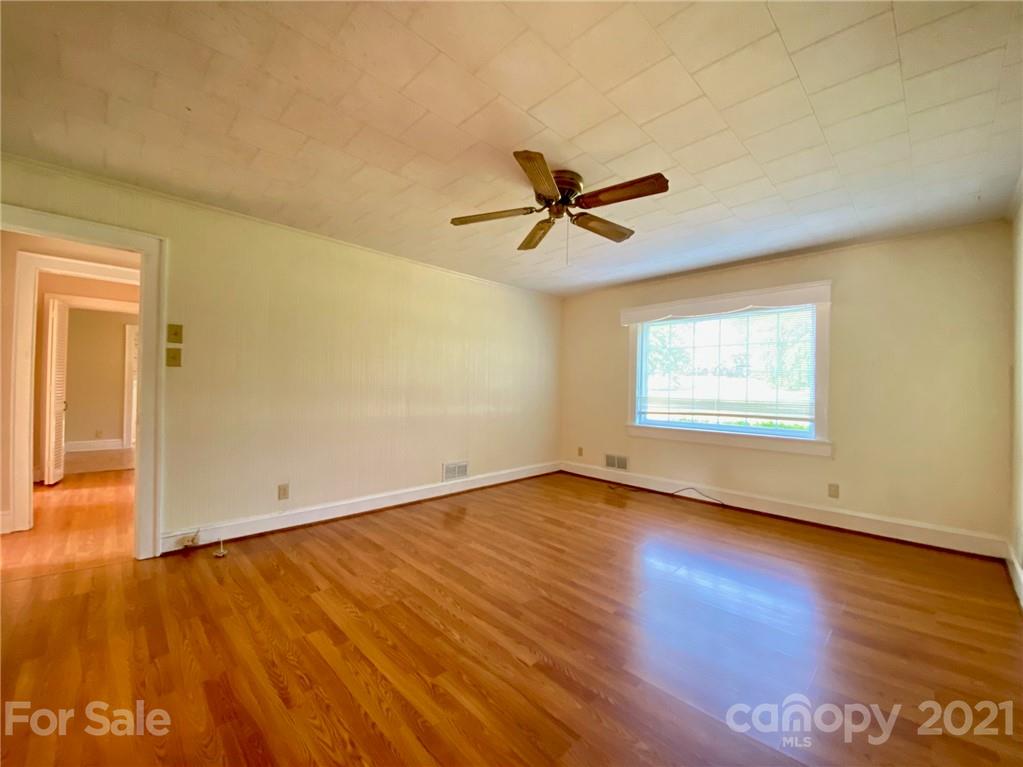 8930 Cool Springs Road Woodleaf, NC 27054 - Photo 5 of 42 an empty room with wooden floor and windows