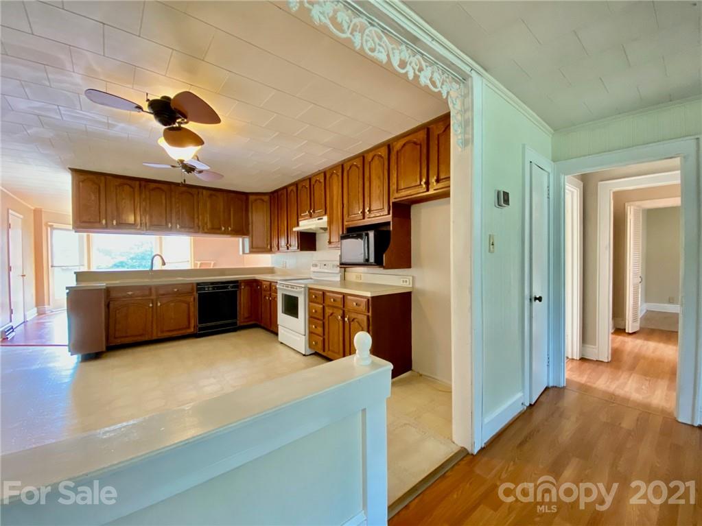 8930 Cool Springs Road Woodleaf, NC 27054 - Photo 7 of 42 a kitchen with stainless steel appliances granite countertop a sink a stove and a refrigerator