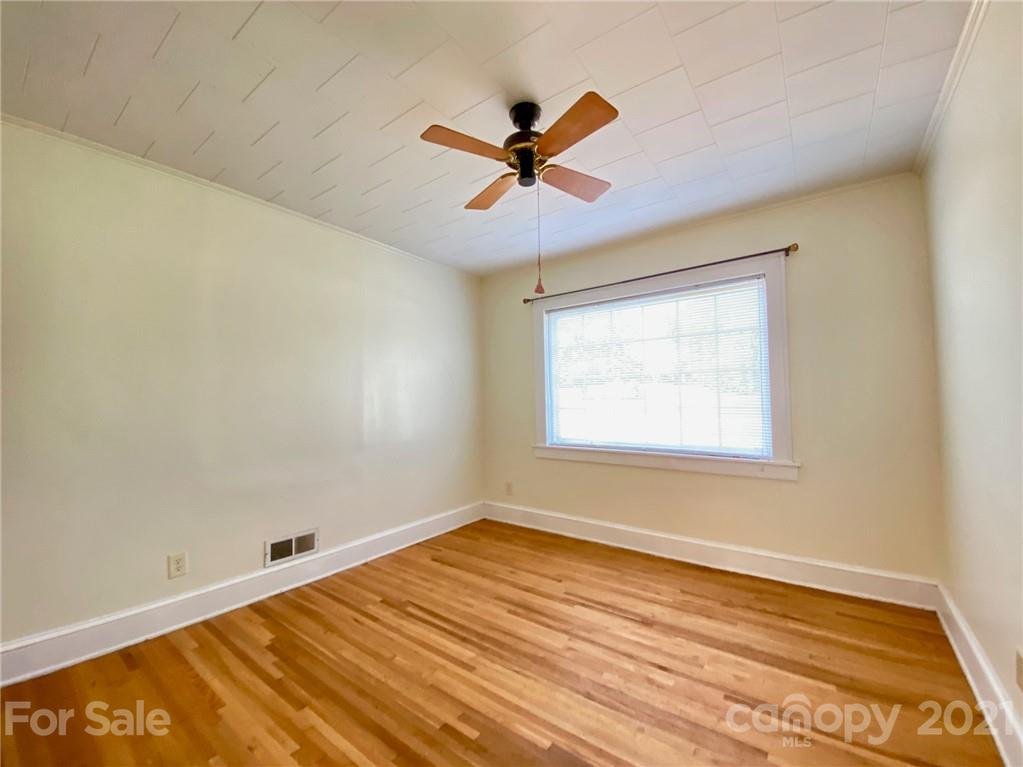 8930 Cool Springs Road Woodleaf, NC 27054 - Photo 9 of 42 a view of a room with wooden floor and a ceiling fan