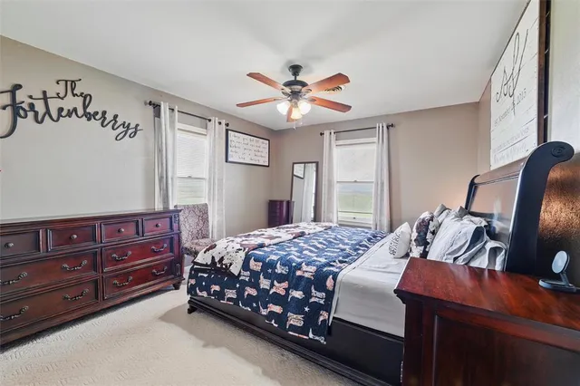 a bedroom with a bed and dresser with mirror