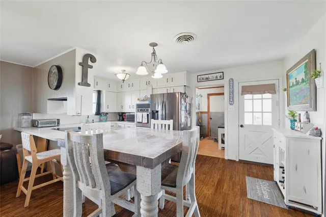 a large kitchen with a table and chairs