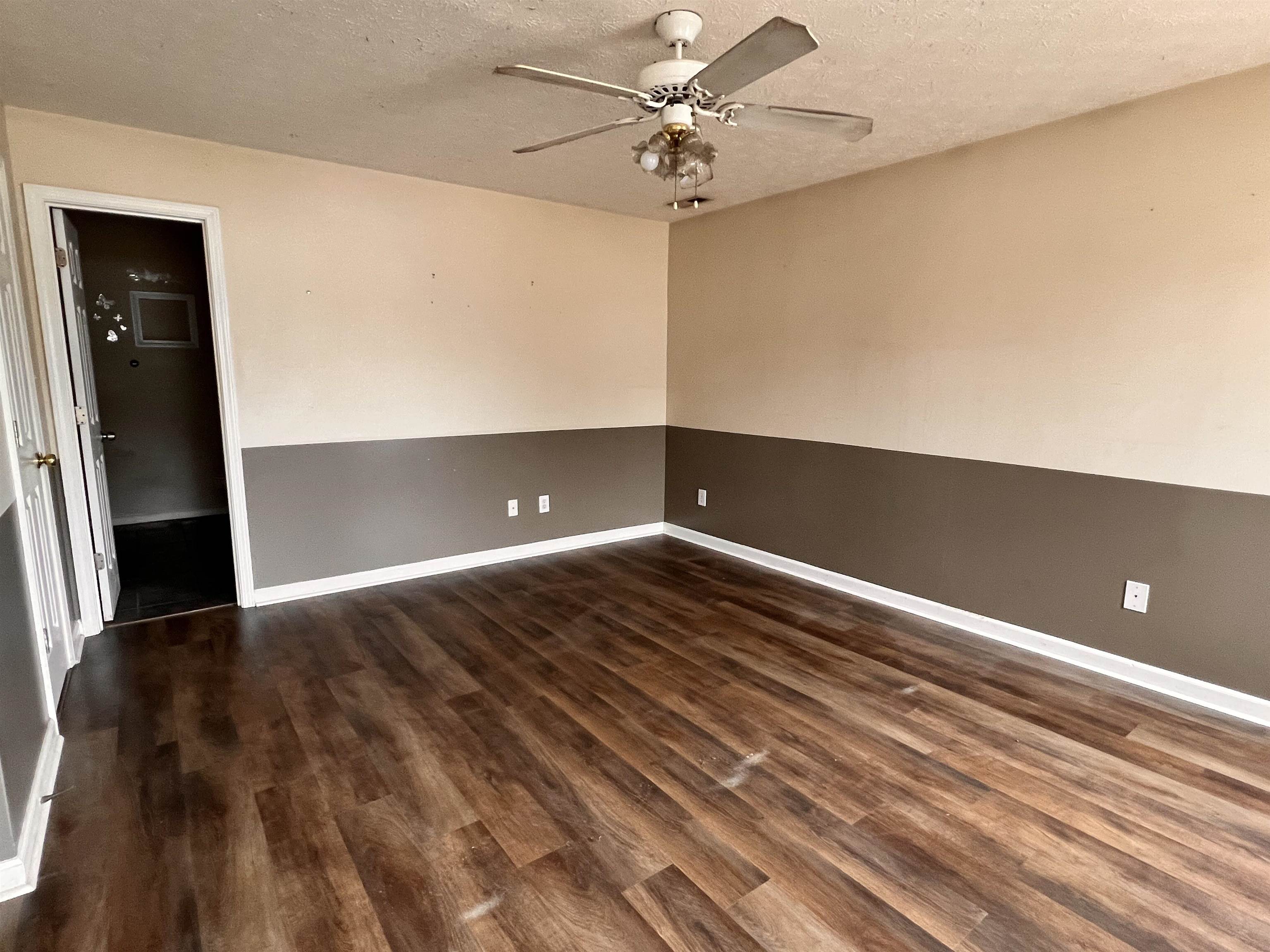 4027 Douglas Fir Lane Murrells Inlet, SC 29576 - Photo 16 of 22 Unfurnished room with dark wood-type flooring, ceiling fan, and a textured ceiling