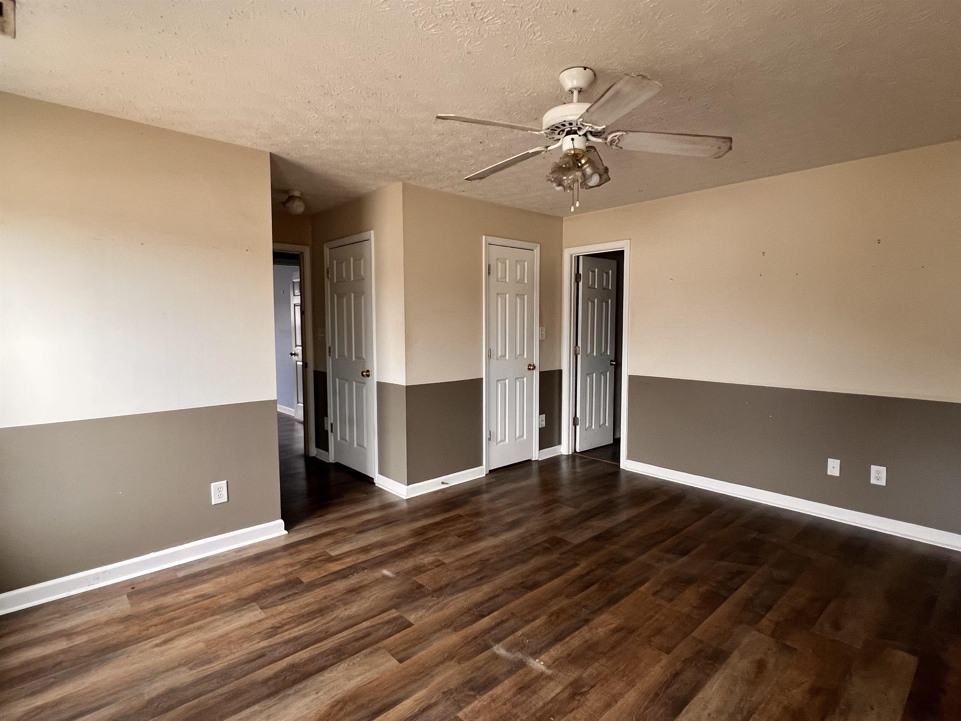 4027 Douglas Fir Lane Murrells Inlet, SC 29576 - Photo 17 of 22 Unfurnished room featuring dark wood-type flooring, a textured ceiling, and ceiling fan