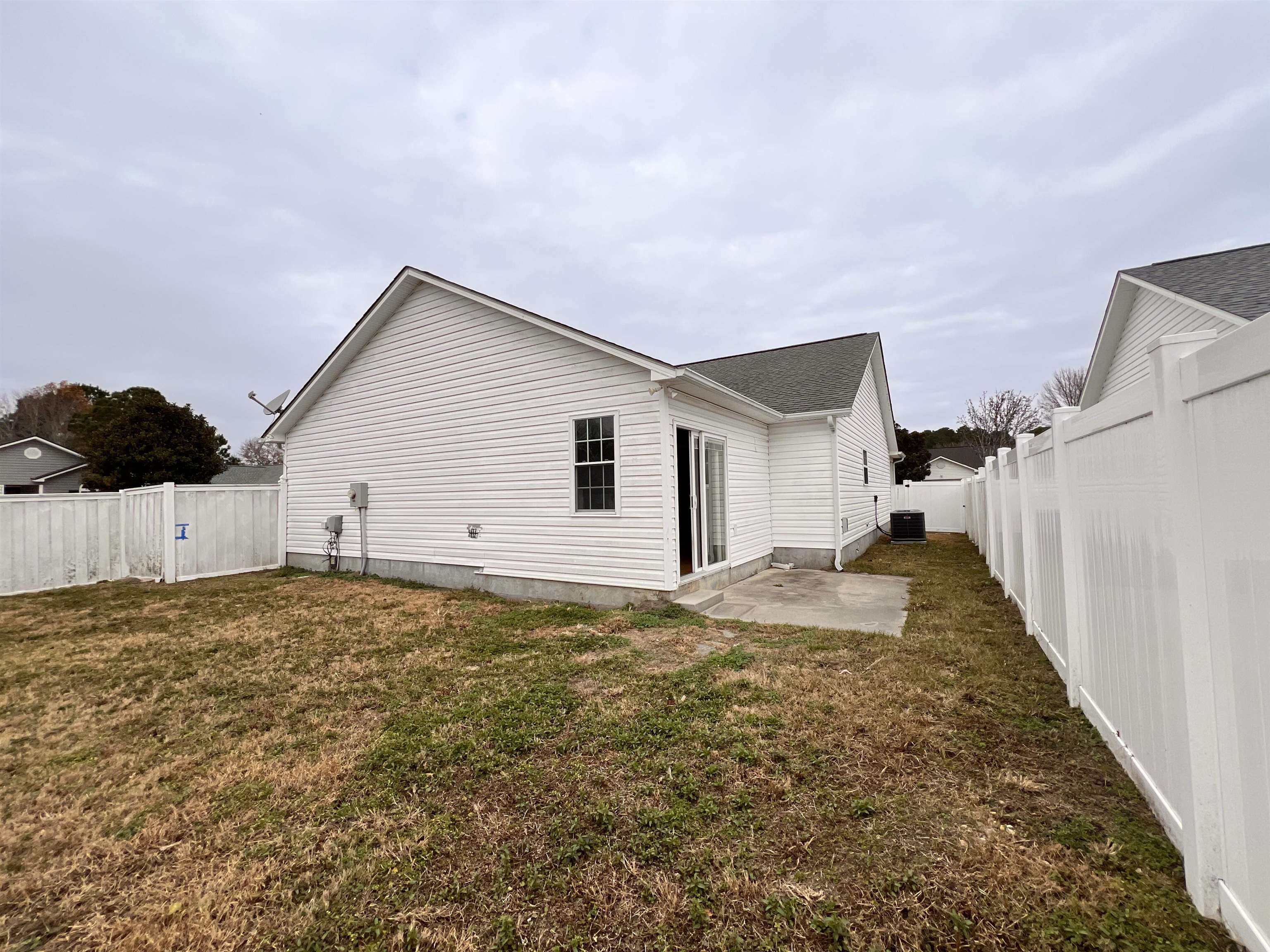 4027 Douglas Fir Lane Murrells Inlet, SC 29576 - Photo 21 of 22 Back of property with a patio area and a fenced backyard