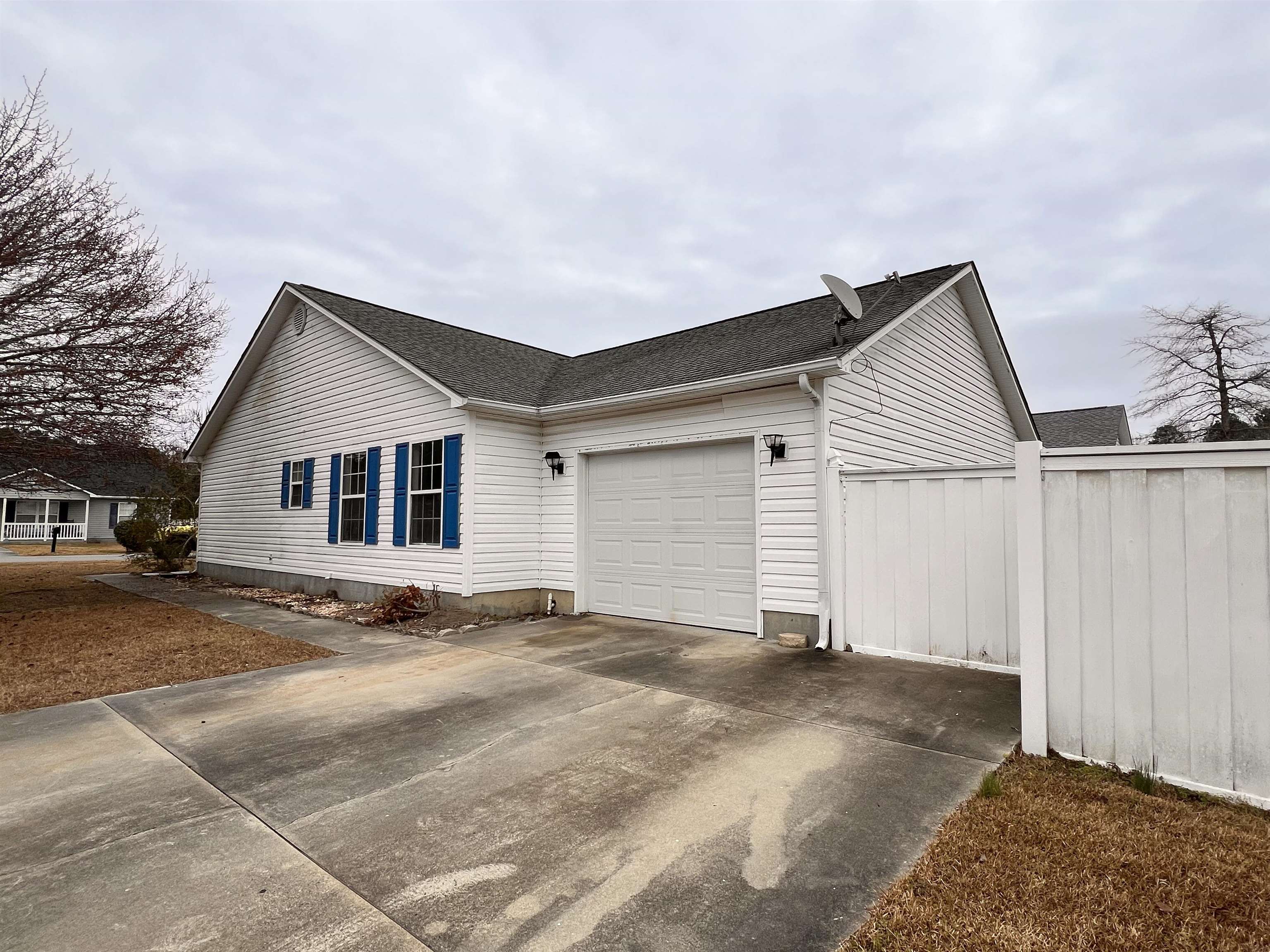 4027 Douglas Fir Lane Murrells Inlet, SC 29576 - Photo 22 of 22 View of side of property with a shingled roof, a garage, and driveway