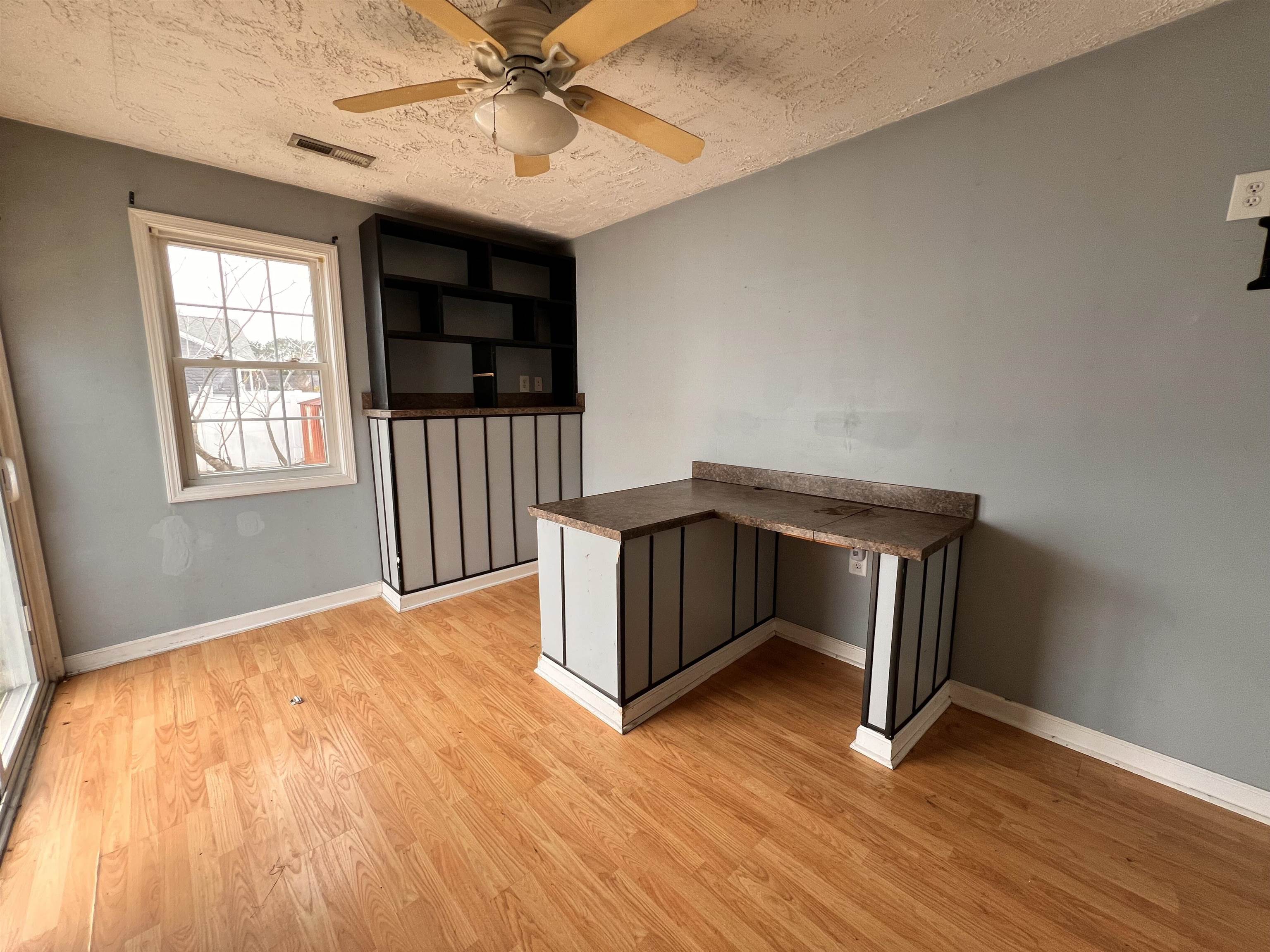 4027 Douglas Fir Lane Murrells Inlet, SC 29576 - Photo 6 of 22 Unfurnished office with a textured ceiling, light wood-style floors, and a ceiling fan