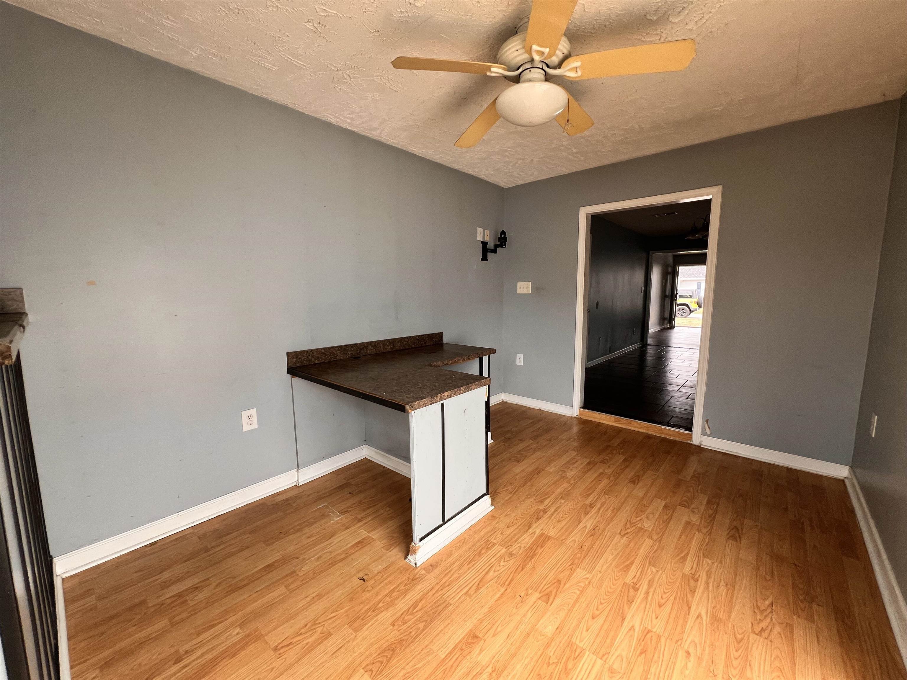 4027 Douglas Fir Lane Murrells Inlet, SC 29576 - Photo 7 of 22 Empty room featuring light wood finished floors, a textured ceiling, and a ceiling fan