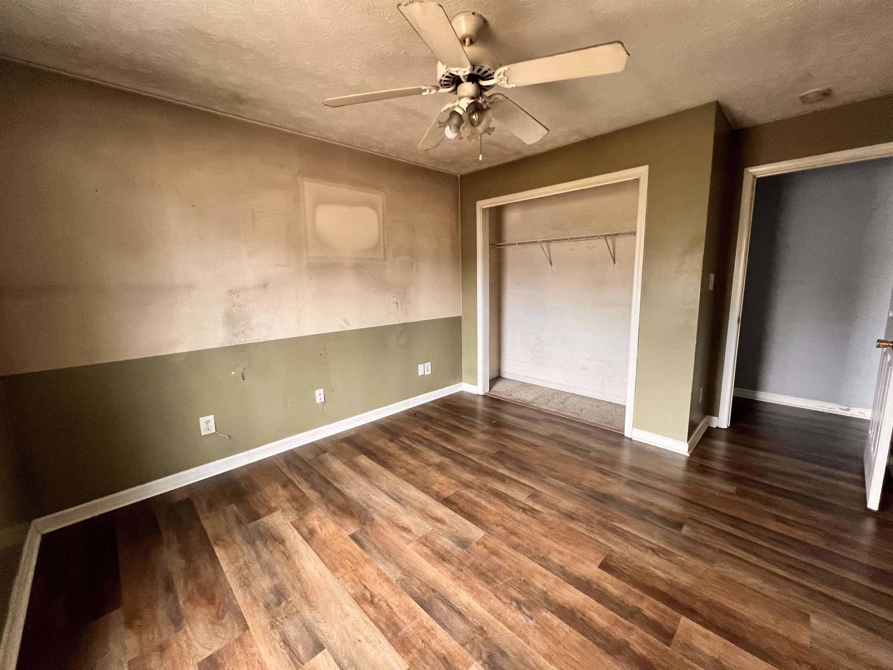 4027 Douglas Fir Lane Murrells Inlet, SC 29576 - Photo 10 of 22 Unfurnished bedroom featuring a closet, dark wood-type flooring, ceiling fan, and a textured ceiling