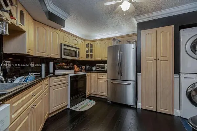 a kitchen with a refrigerator stove and wooden cabinets