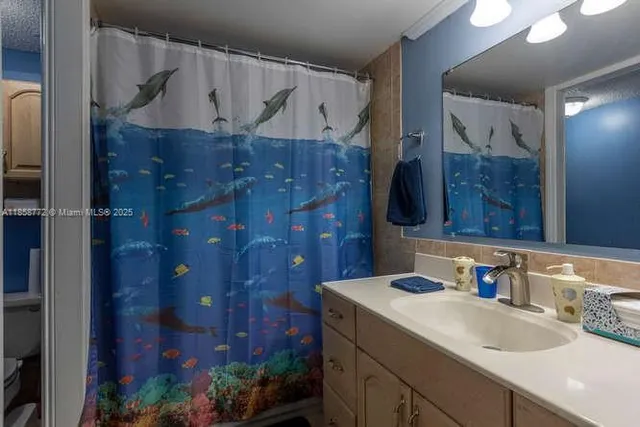 a bathroom with a sink vanity and a mirror
