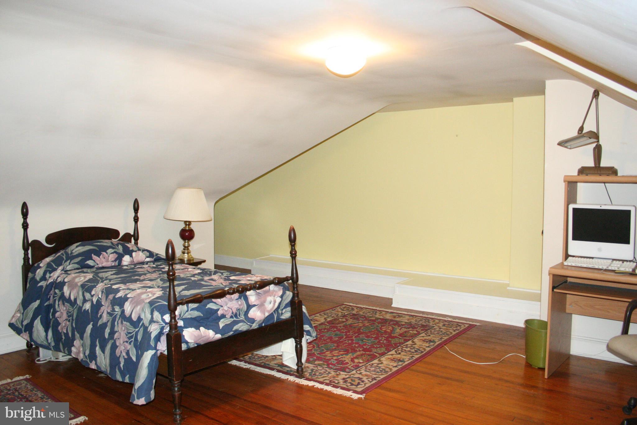 216 Dunkirk Road Baltimore, MD 21212 - Photo 11 of 21 a bedroom with a bed and wooden floor