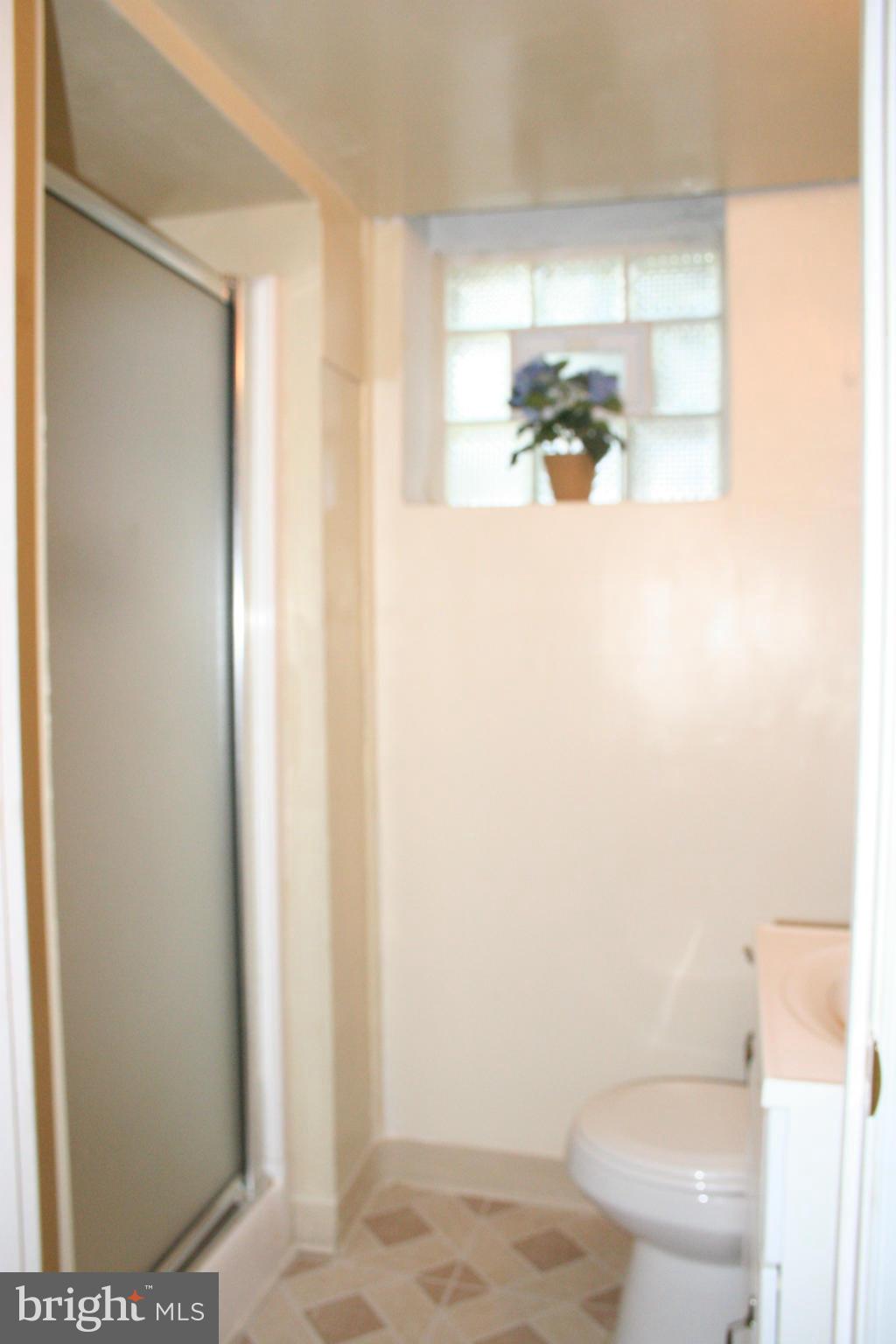 216 Dunkirk Road Baltimore, MD 21212 - Photo 15 of 21 a bathroom with a toilet and a shower