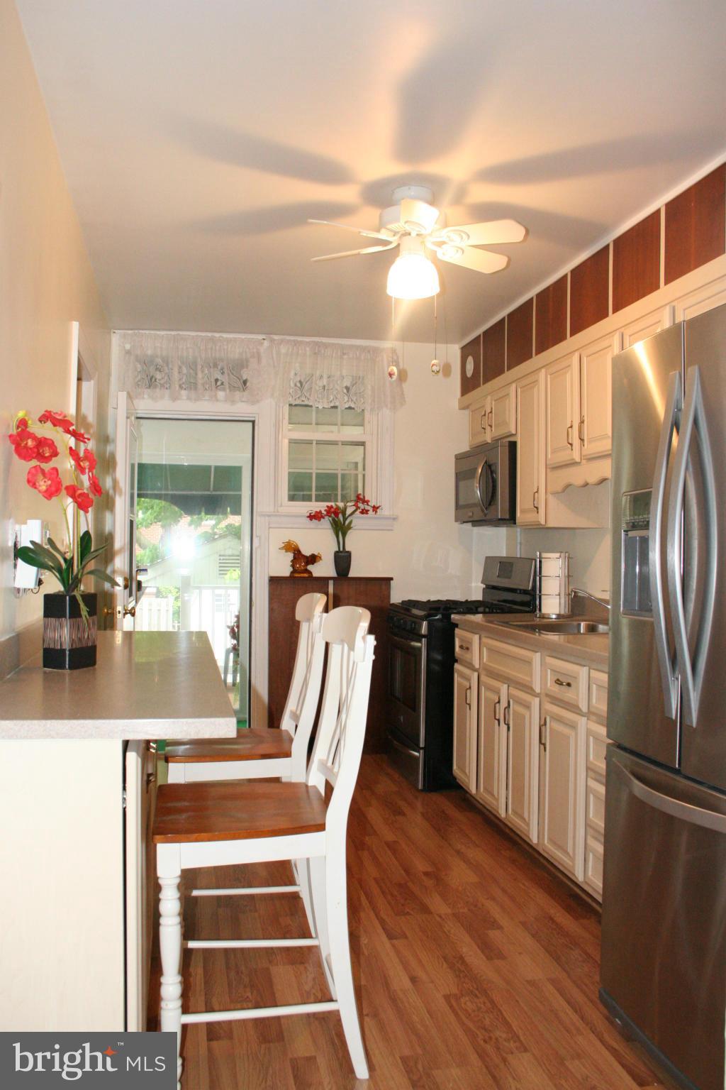 216 Dunkirk Road Baltimore, MD 21212 - Photo 5 of 21 a view of a kitchen with furniture and a potted plant