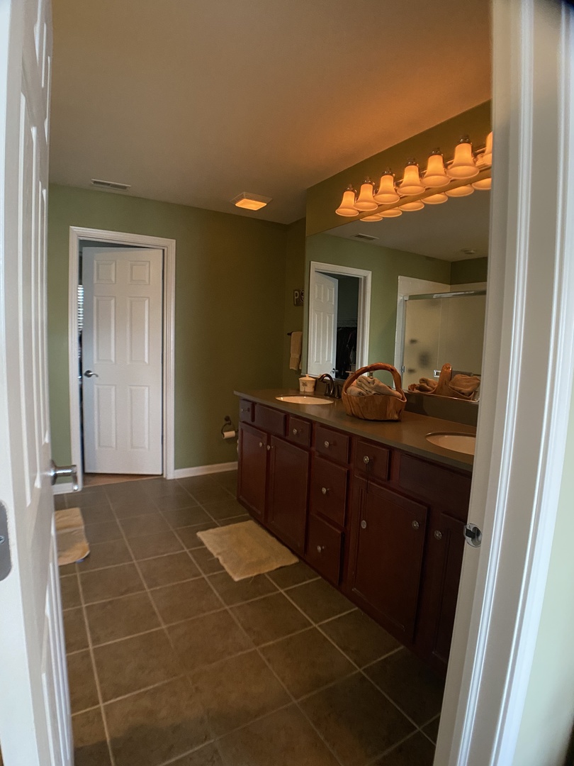 3029 Range Road Elgin, IL 60124 - Photo 10 of 20 a room with a wooden cabinet and mirror