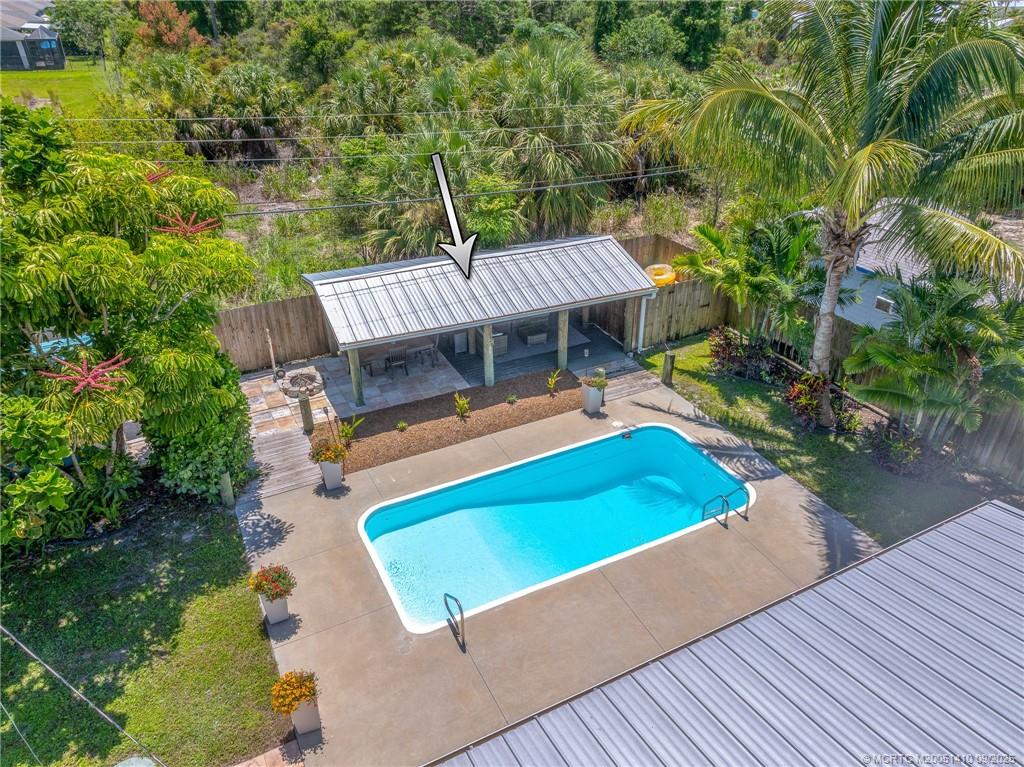 2859 Northeast Hickory Ridge Avenue Jensen Beach, FL 34957 - Photo 12 of 32 a view of a backyard with a patio and deck