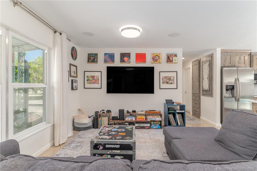 2859 Northeast Hickory Ridge Avenue Jensen Beach, FL 34957 - Photo 14 of 32 a living room with furniture and a flat screen tv
