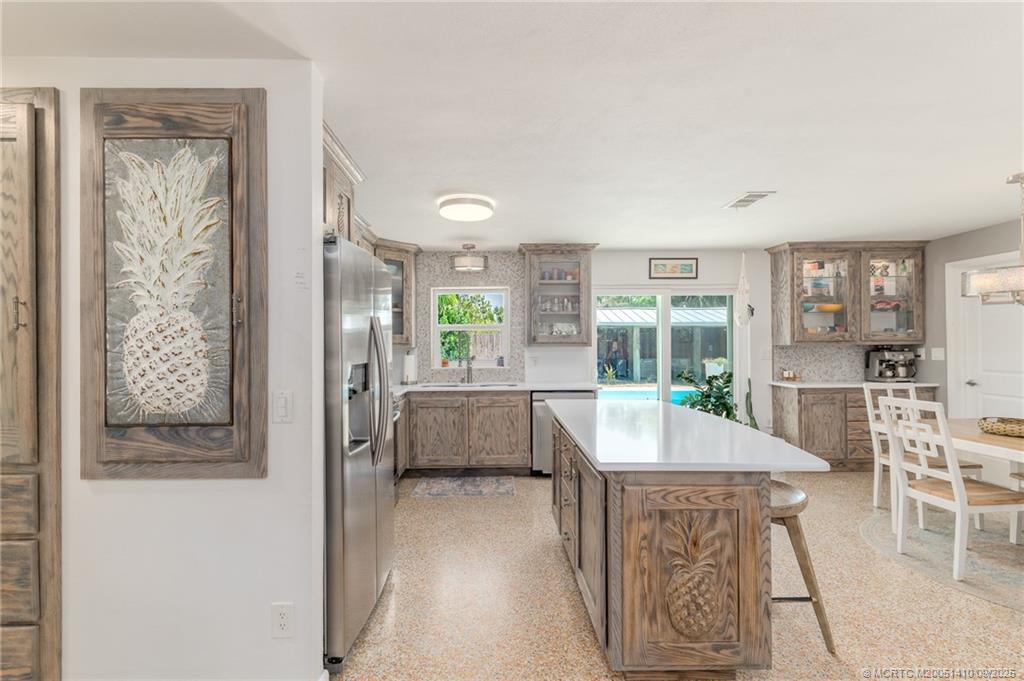 2859 Northeast Hickory Ridge Avenue Jensen Beach, FL 34957 - Photo 17 of 32 a living room with furniture and a table