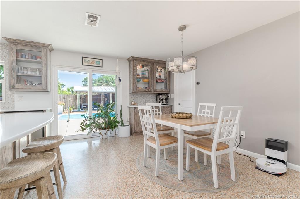 2859 Northeast Hickory Ridge Avenue Jensen Beach, FL 34957 - Photo 18 of 32 a view of a dining room with furniture window and wooden floor