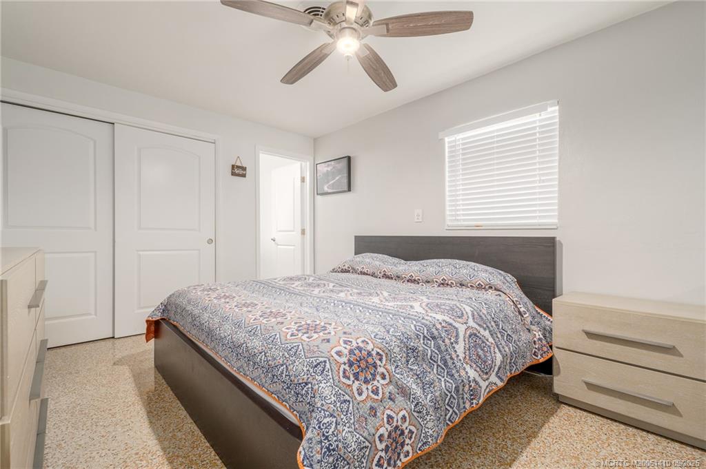 2859 Northeast Hickory Ridge Avenue Jensen Beach, FL 34957 - Photo 19 of 32 a bedroom with bed and window
