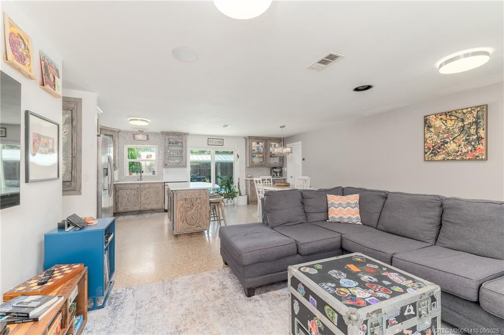 2859 Northeast Hickory Ridge Avenue Jensen Beach, FL 34957 - Photo 2 of 32 a living room with furniture and a couch