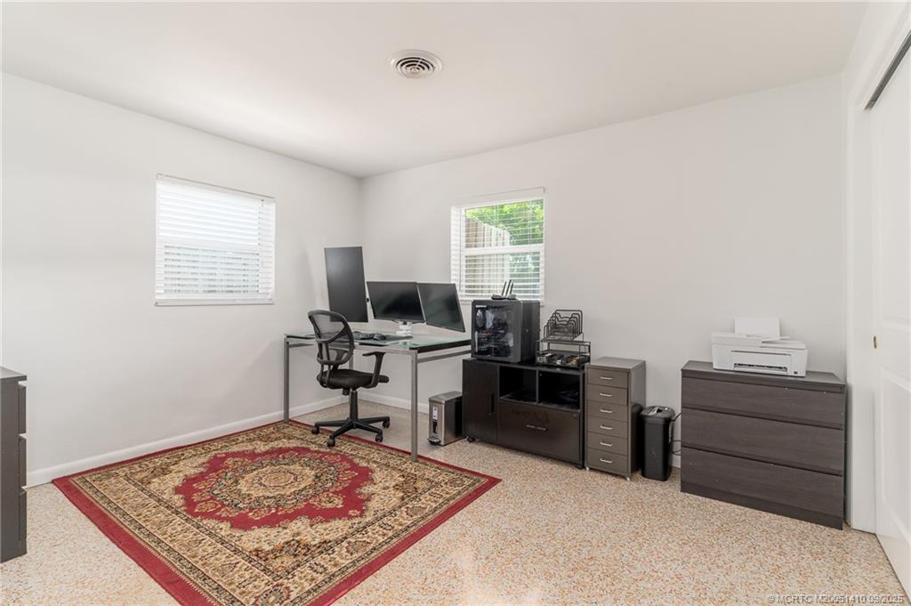 2859 Northeast Hickory Ridge Avenue Jensen Beach, FL 34957 - Photo 21 of 32 a view of a workspace with furniture and a window