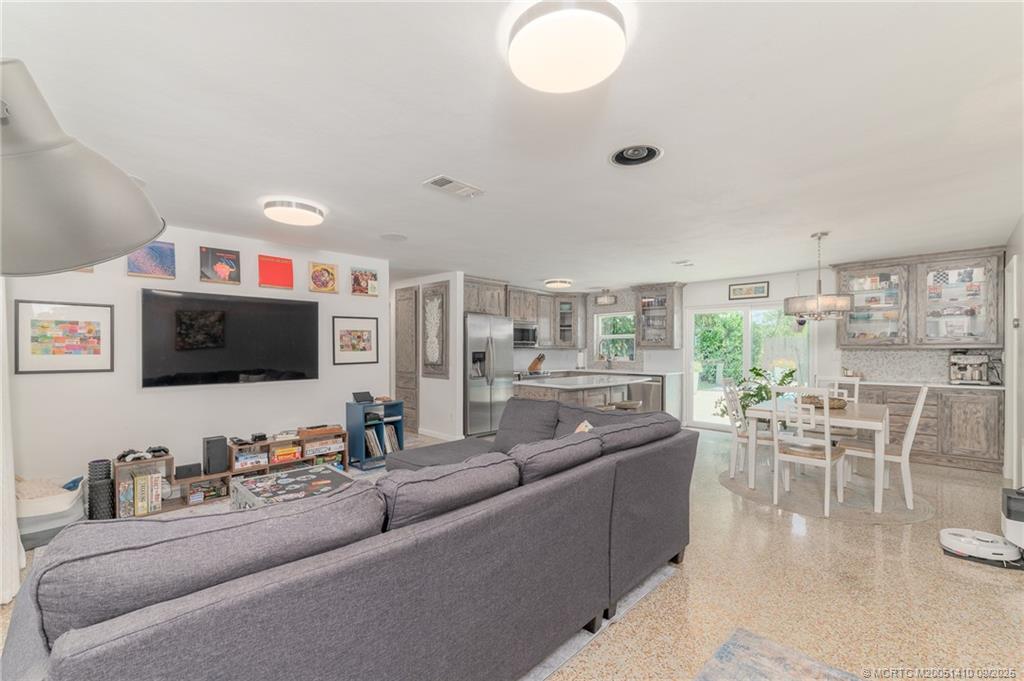 2859 Northeast Hickory Ridge Avenue Jensen Beach, FL 34957 - Photo 3 of 32 a living room with furniture and a flat screen tv