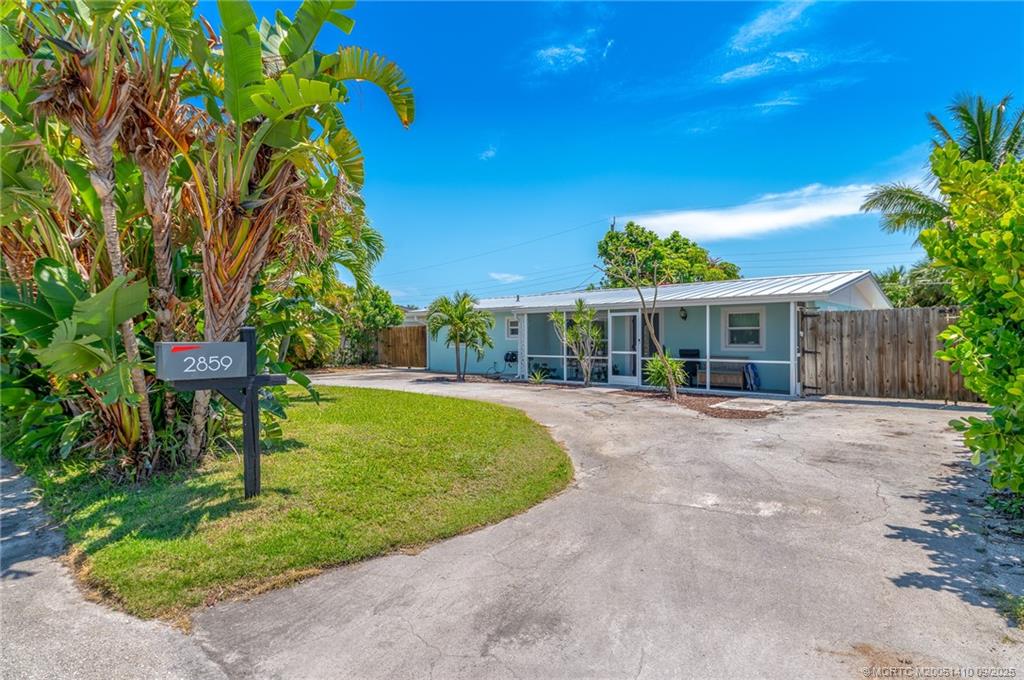 2859 Northeast Hickory Ridge Avenue Jensen Beach, FL 34957 - Photo 32 of 32 a view of a house with a yard