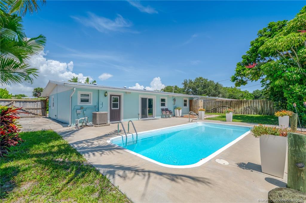 2859 Northeast Hickory Ridge Avenue Jensen Beach, FL 34957 - Photo 4 of 32 a view of a house with swimming pool and sitting area