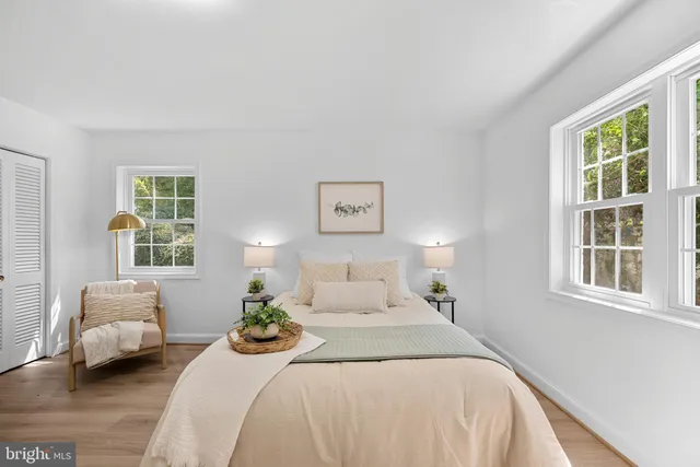 a bedroom with a bed couches and a window