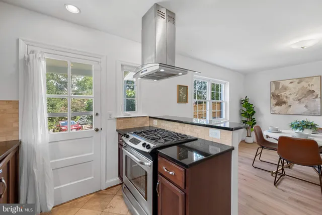 a kitchen that has a stove and a chair
