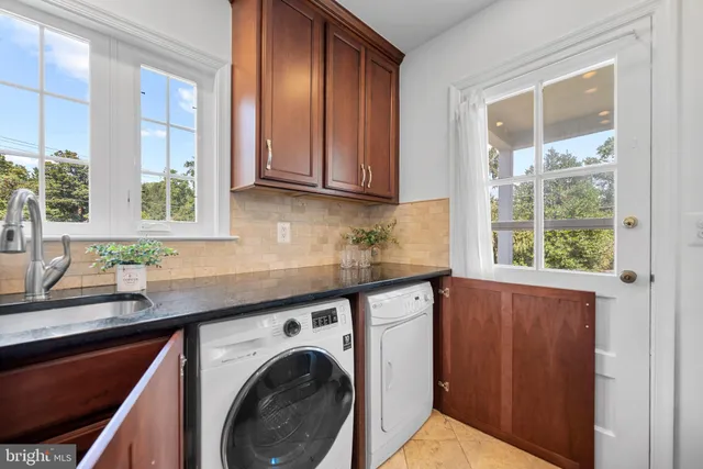 a kitchen with stainless steel appliances a sink a stove and cabinets
