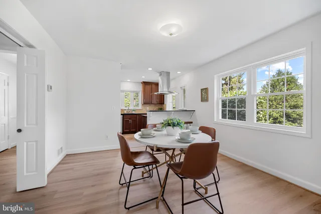 a view of a dining room with furniture and a window