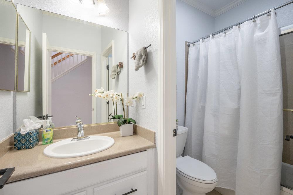 1120 Violet Way Gilroy, CA 95020 - Photo 13 of 39 a bathroom with a granite countertop sink toilet and shower