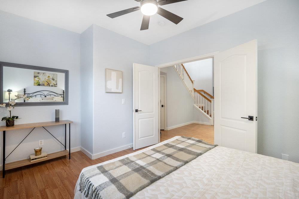 1120 Violet Way Gilroy, CA 95020 - Photo 16 of 39 a bedroom with a bed and a chandelier