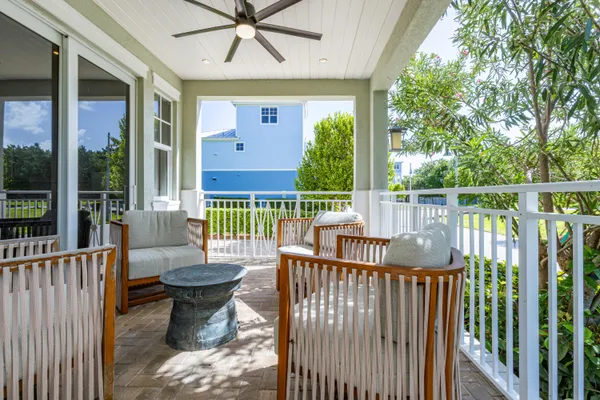 an aerial view of a house with a yard and outdoor seating