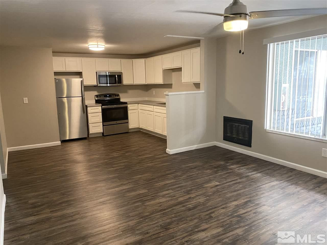 a kitchen with stainless steel appliances a refrigerator and a stove top oven