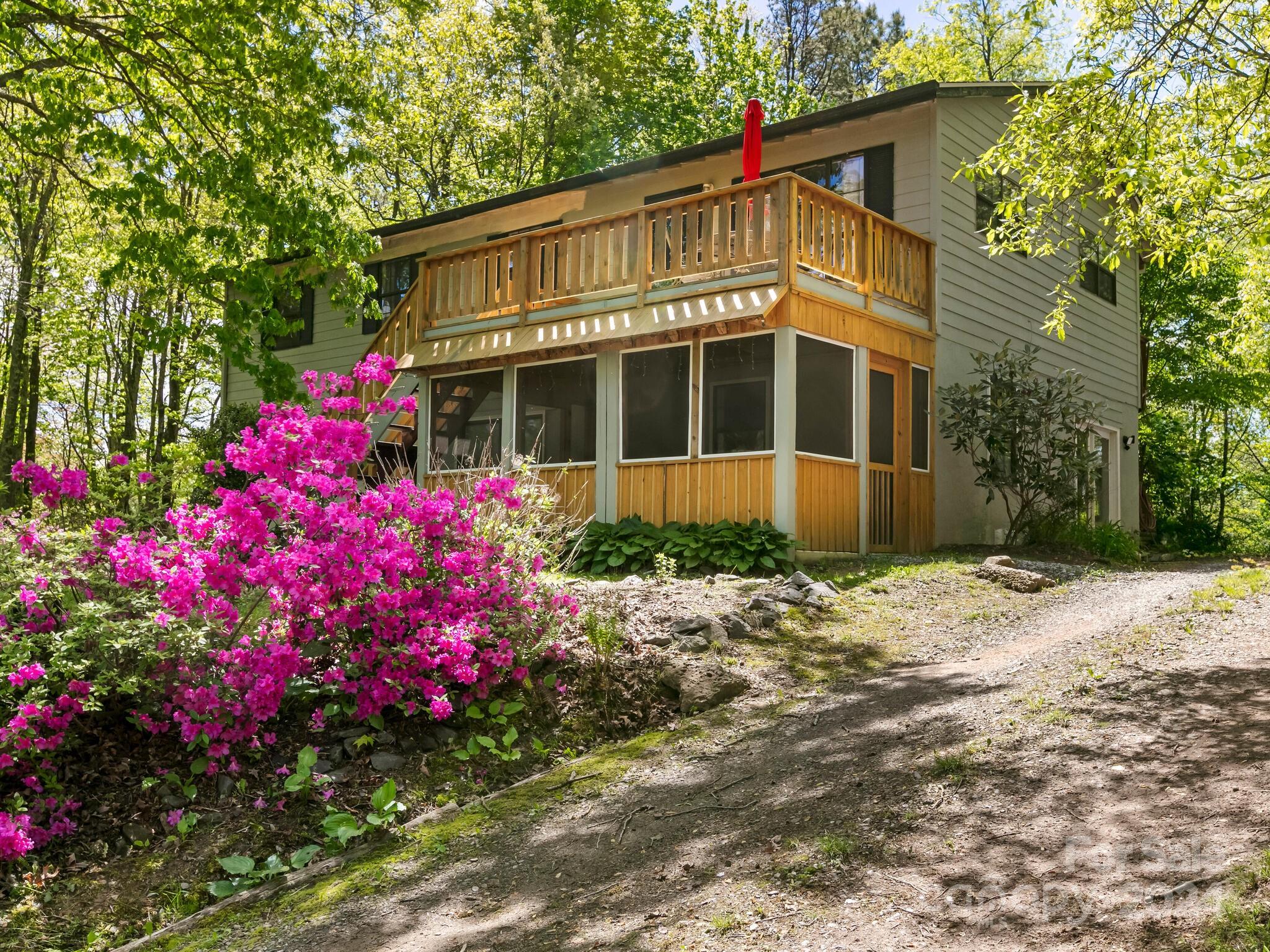 a front view of a house with a yard and fountain