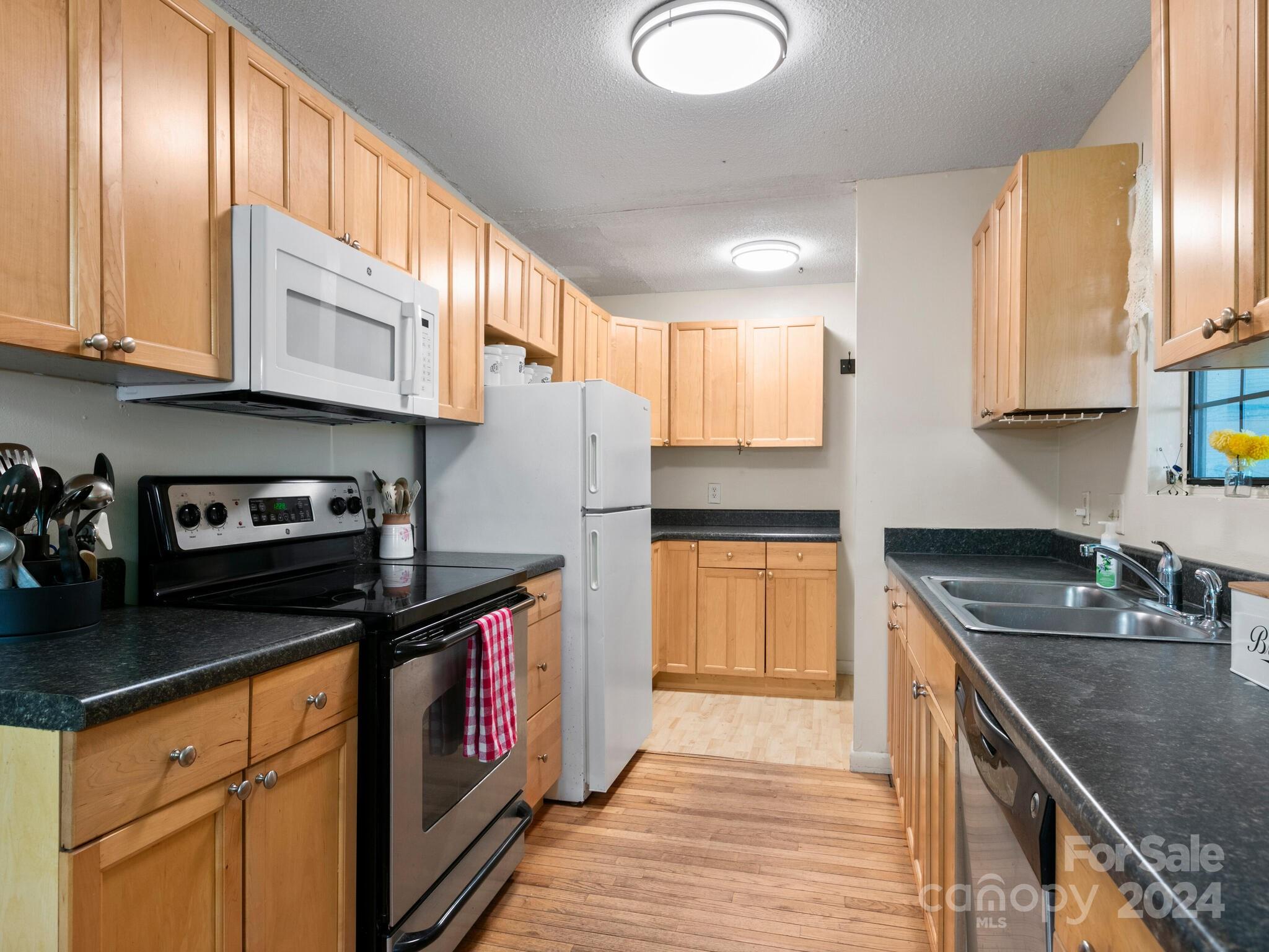46 New Lite Road Fairview, NC 28730 - Photo 12 of 31 a kitchen with stainless steel appliances granite countertop a sink a stove and a refrigerator