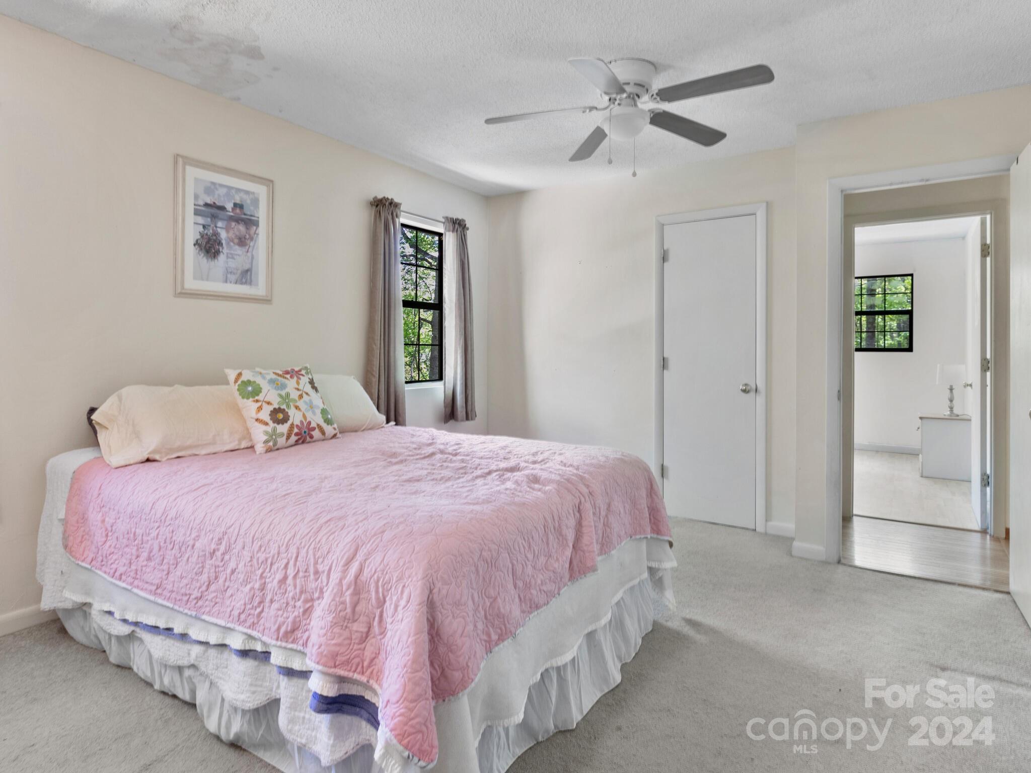 46 New Lite Road Fairview, NC 28730 - Photo 22 of 31 a bedroom with a bed and a chandelier