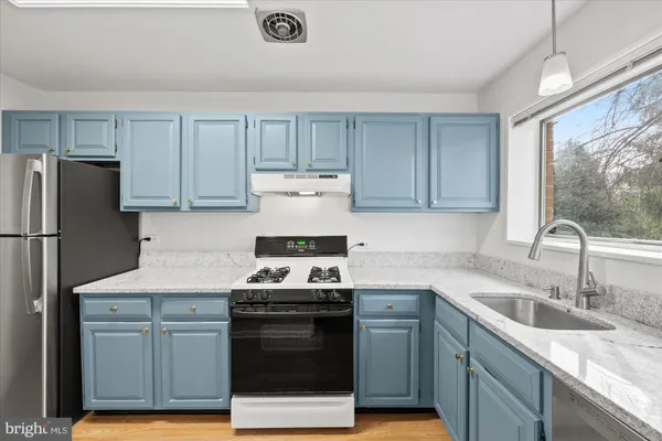 a kitchen with a sink appliances and cabinets