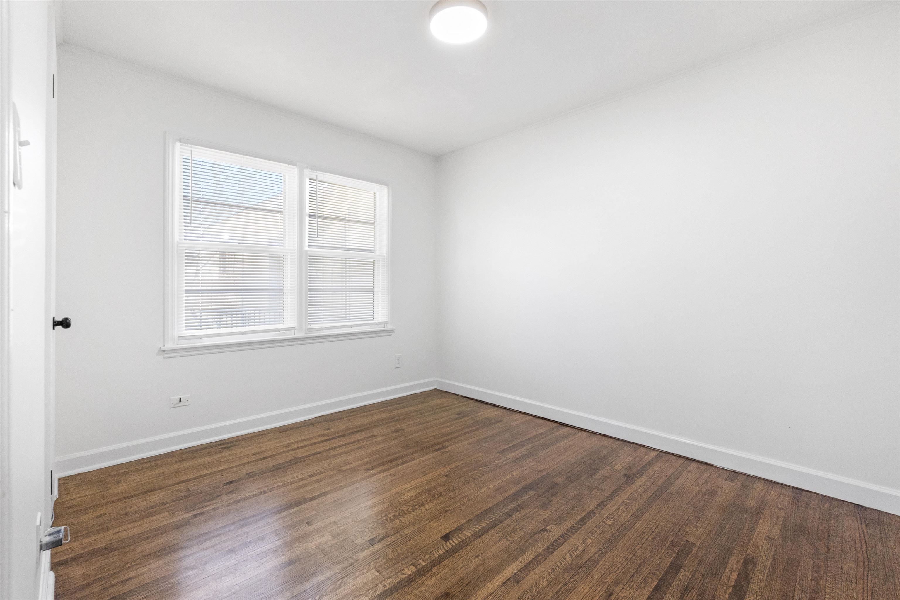 4580 Helene Road Memphis, TN 38117 - Photo 3 of 25 Unfurnished room featuring dark wood-type flooring and baseboards