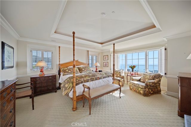 a bedroom with furniture and a chandelier