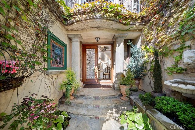a front view of a house with a garden