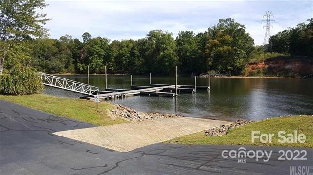 151 Pier Point Drive, Unit 9 Stony Point, NC 28678 - Photo 17 of 18 a view of a lake with a wooden fence
