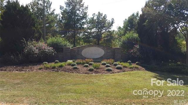 151 Pier Point Drive, Unit 9 Stony Point, NC 28678 - Photo 2 of 18 a backyard of a house with lots of green space and a fountain