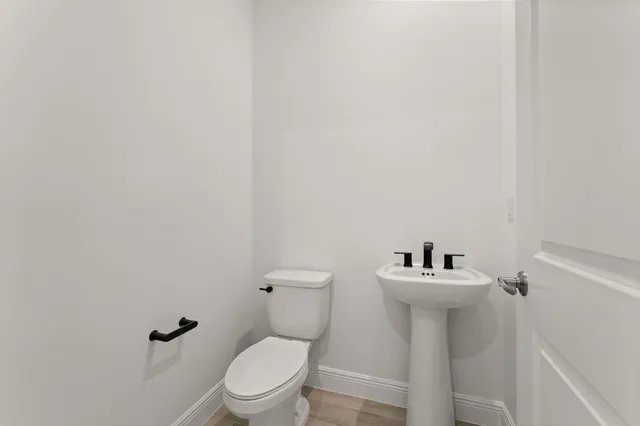 a white toilet sitting next to a white sink