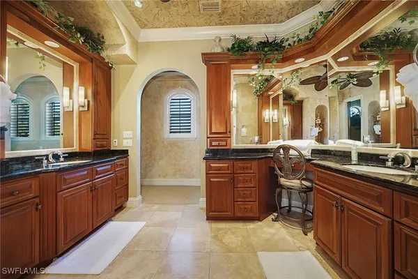 a bedroom with a bed a table and chairs