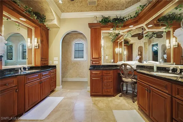 a bedroom with a bed a table and chairs